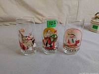 All three Coca-Cola Christmas glasses side by side