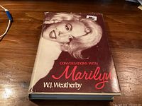 Front cover of hardcover book showing title, author, dust jacket wear