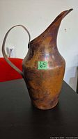Left side view showing full shape, patina, handle attachment
