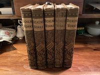 Five volumes standing upright showing decorative spines