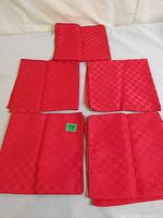 Five red checkerboard napkins laid out