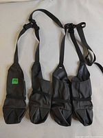Full view showing four boots connected by harness straps