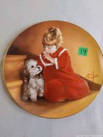 Full view of collector plate with girl and dog artwork
