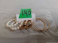 All three pairs of earrings in a clear bag