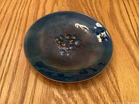 Front view showing blue enamel finish and raised center design
