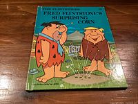 Front cover of the Flintstones book showing title, characters, publication price, Hanna-Barbera marking