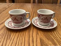 Two cups with two saucers displayed on table