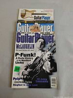 Stack of three Guitar Player magazines showing partial covers including April 1996 issue