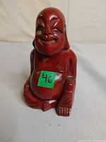 Front view of carved wooden Happy Buddha statuette