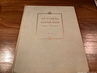 Front cover showing title, gilt crown, cream cloth binding