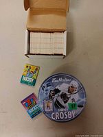 Tin puzzle, card box, two sealed packs overview