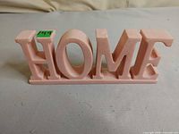 Front view of pink HOME sign