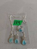 Full view of necklace, ring, and three teardrop components