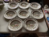 Eight dinner plates arranged on table showing pattern