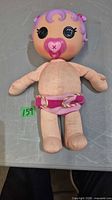 Front view of cloth-body Lalaloopsy baby doll showing button eyes, pacifier and diaper