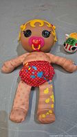 Full view of doll front with diaper and bottle accessory