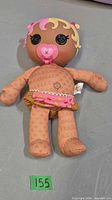 Full front view of doll showing body, pacifier, and skirt
