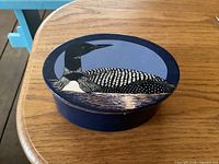 Leather box with lid showing loon illustration