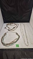 All four necklaces laid out for overview