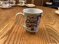 Front view of ceramic mug showing main graphic and caption
