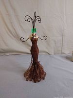 Full frontal view of mannequin jewelry stand