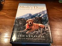 Front cover of Merle’s Door hardcover book showing title, author, award note and cover art