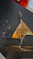 Both metal pieces side by side on tabletop