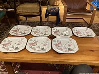Seven Mikasa Silk Flowers dinner plates displayed top side up on table