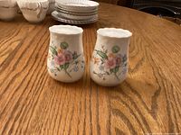 Front view of both shakers showing floral design