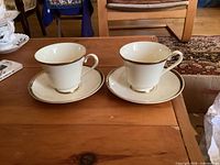 Pair of teacups on saucers showing overall style and pattern
