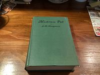 Front cover of green cloth hardcover showing title Mistress Pat