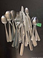 Pile of mixed stainless flatware pieces