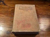 Front cover of worn beige cloth hardcover
