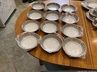 Twelve Noritake Scheherazade soup bowls on table, six wrapped