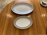 Top view of two oval Noritake Scheherazade platters showing size difference and patterned rims