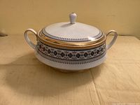 Lidded casserole showing overall design, handles, and finial