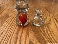 Both glass paperweights side by side for size comparison