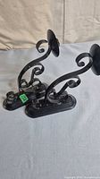 Front view of both black metal scroll sconces