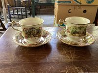 Two Paragon Chippendale teacups with saucers on table