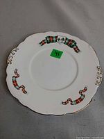 Front view of plate showing tartan ribbon and crest on white bone china