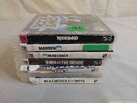 Stack of seven PS3 game cases showing spines