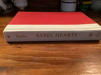 Spine view of Rebel Hearts hardcover book showing title and author Toolis