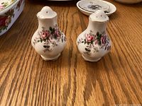 Front view of both shakers showing floral pattern