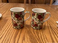 Front view of two matching Royal Albert Old Country Roses mugs