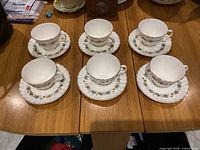 Six teacups with matching saucers displayed on table