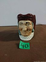 Front view of Royal Doulton Toby jug with lot number 40 visible