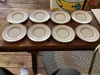 Eight matching bread plates displayed top side