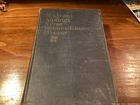 Front cover showing title, publisher emblem, wear on blue cloth boards