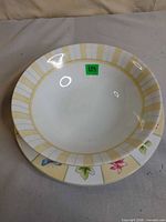 Salad bowl stacked on matching plate showing rim patterns