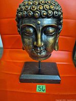 Full view of Buddha head on stand showing size and color